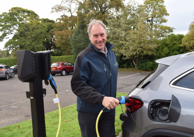 Architectural Manager Craig Veldon using the first EV charger to be installed at our Larbert office