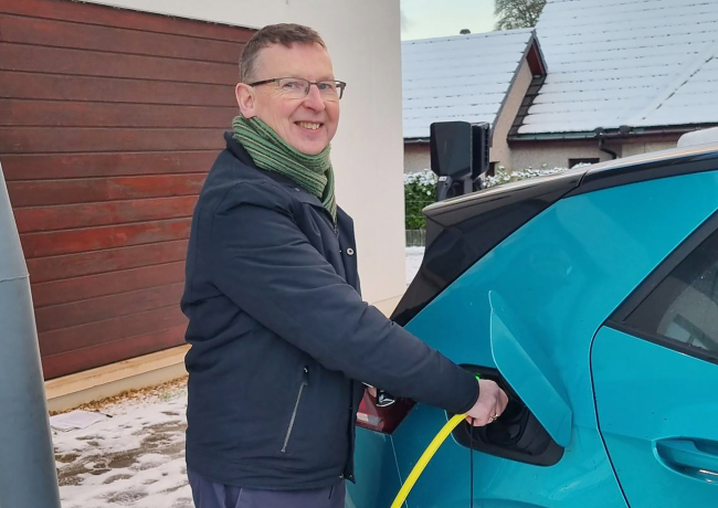 Kevin charging electric car.